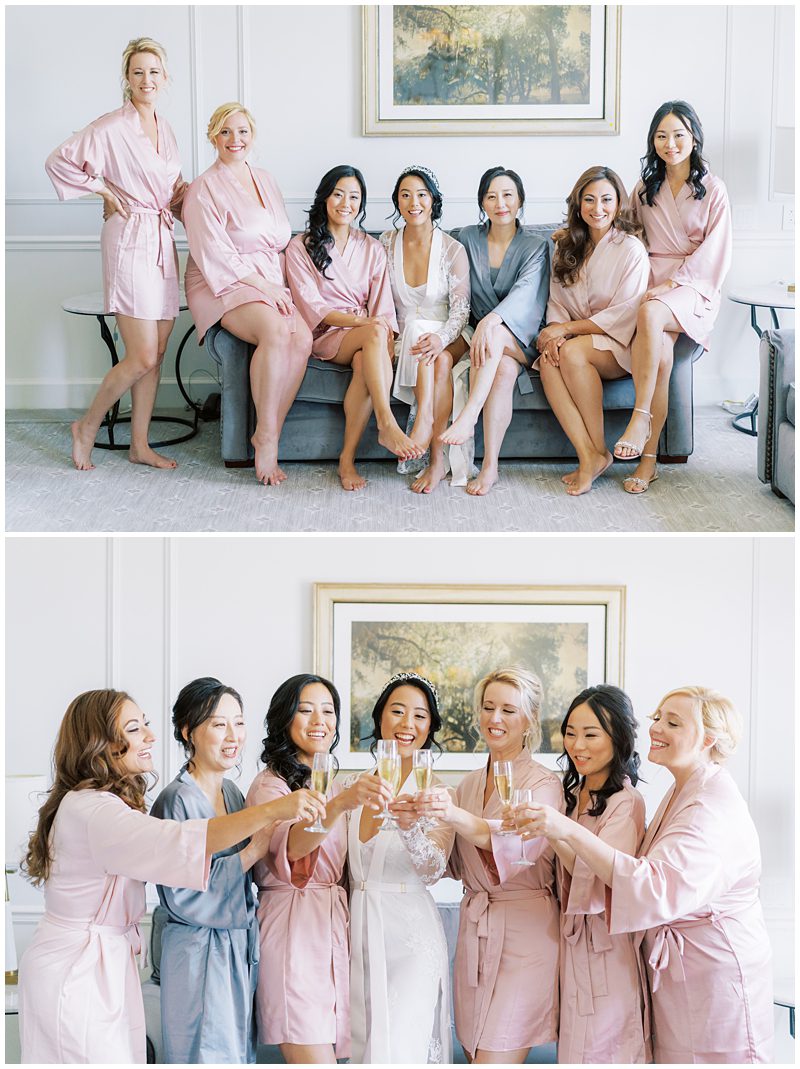 bridesmaids in pink robes cheersing 