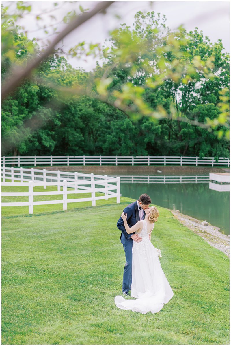 Bride and groom kissing by the lake at Bluestone Estate in PA