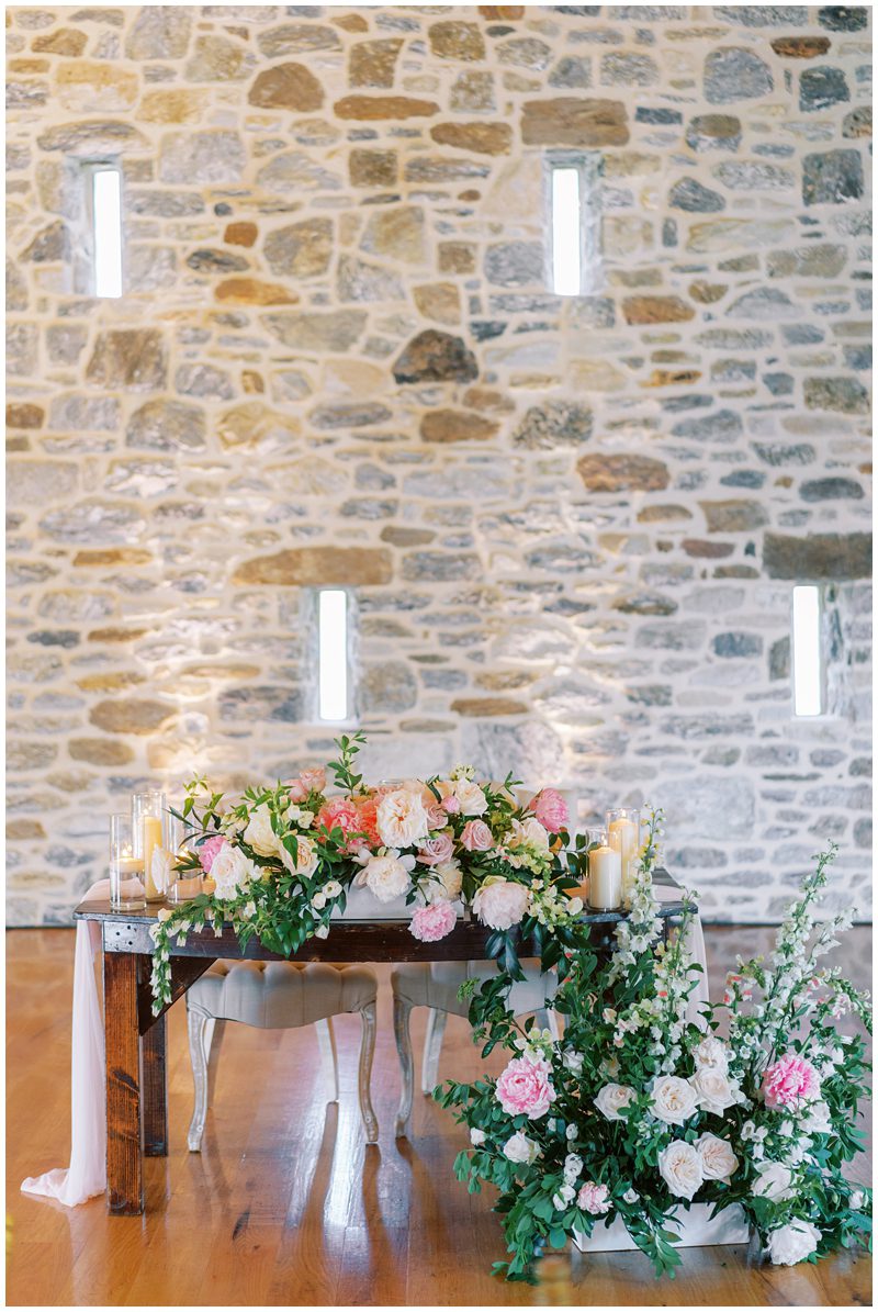 wedding head table with cascading floral decor 