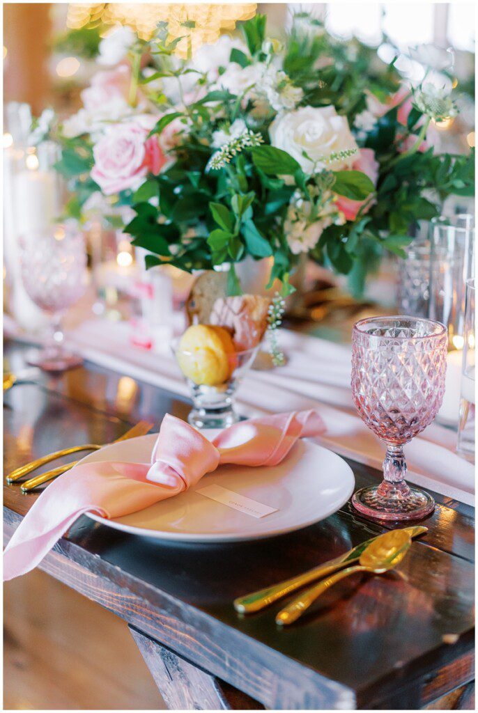 satin pink napkins and purple goblets at a wedding reception 