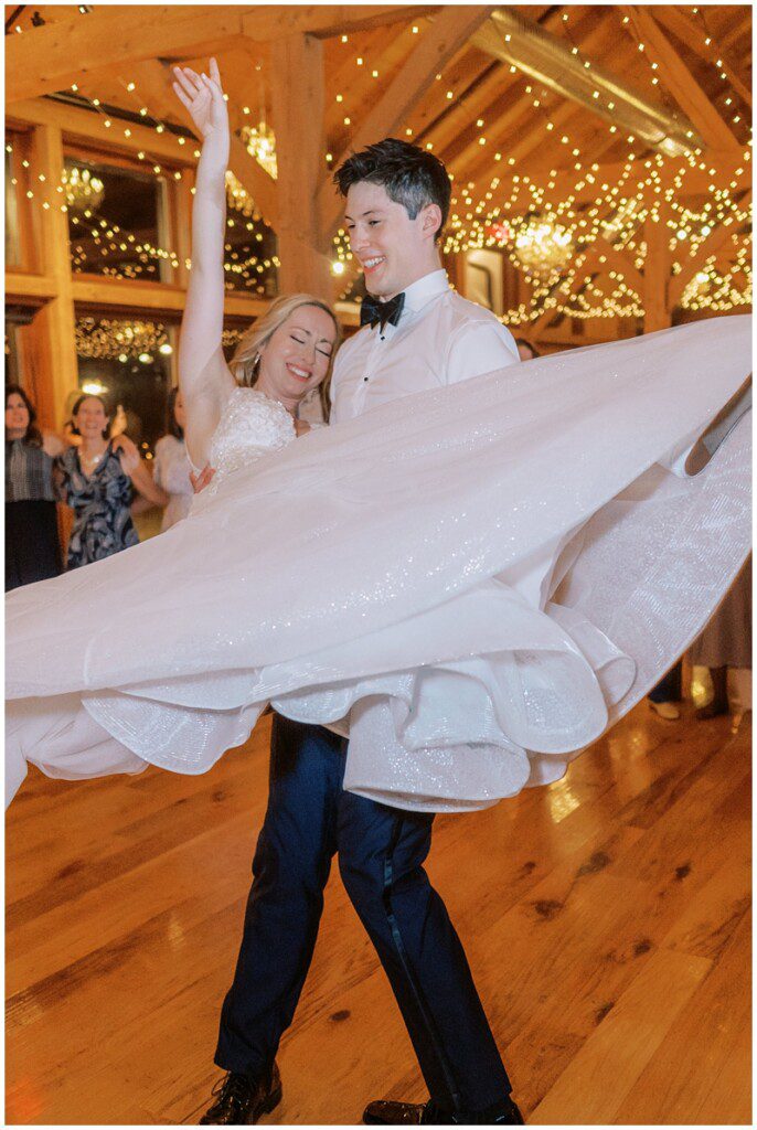 Groom picking up the bride and spinning her around on the dance floor at the their Bluestone Estate wedding in PA