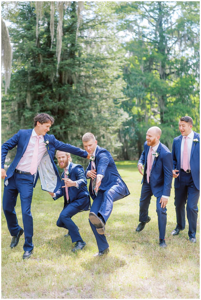fun wedding pic of groom and groomsman being silly 
