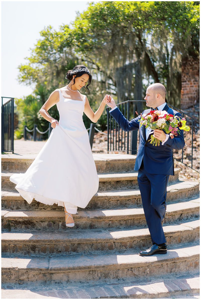 Groom helping the bride some steps at Middleton Place