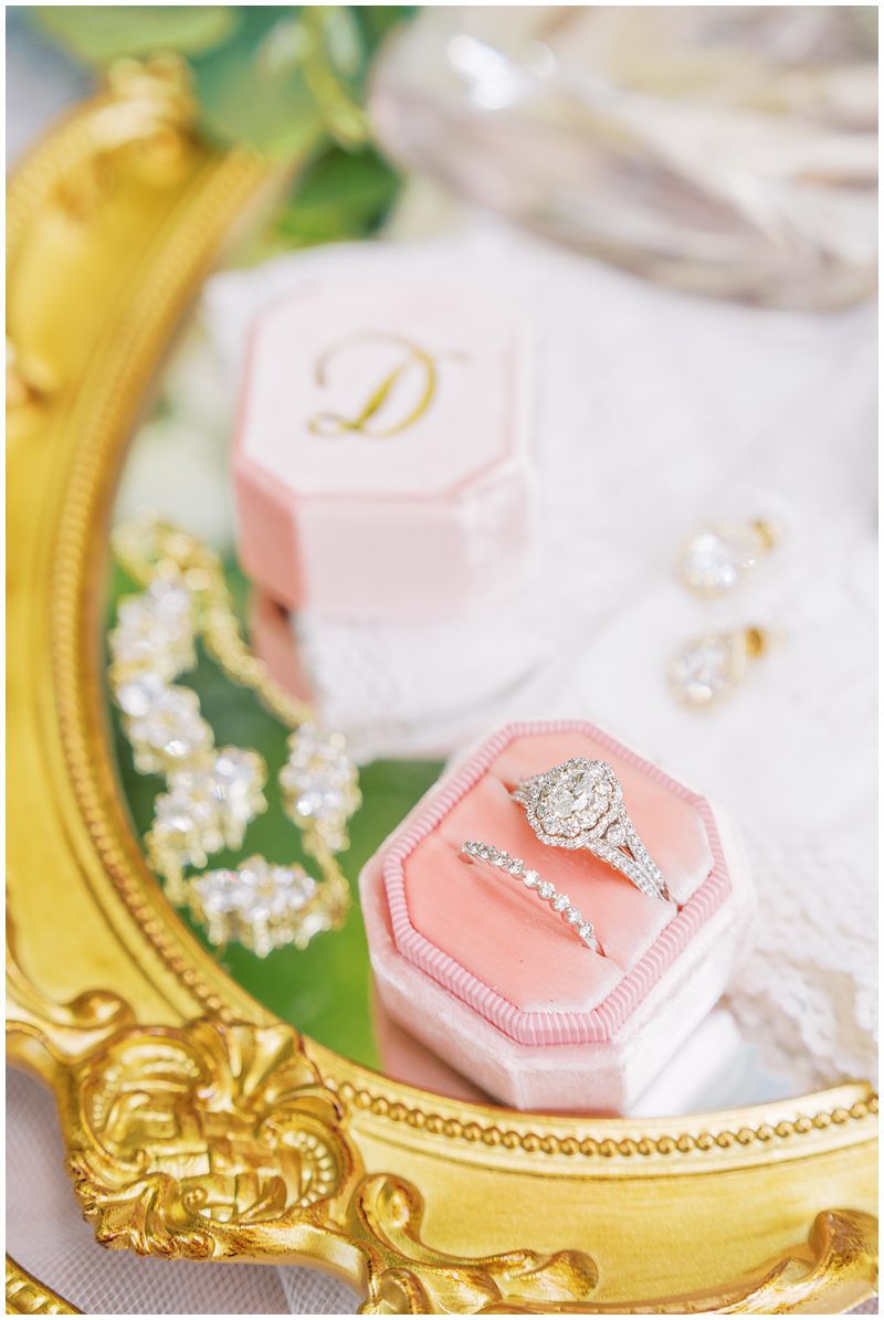 brides pink and gold wedding details with her diamond engagement ring in a pink velvet Mrs Box