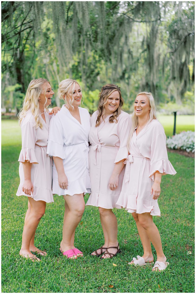 bridesmaids wearing pink robes