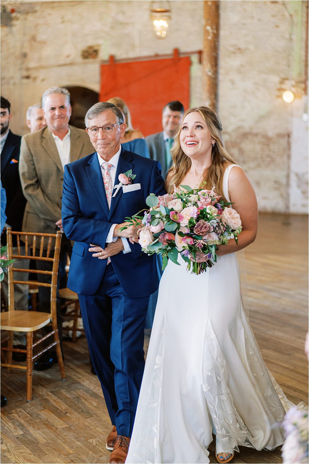 emotional bride walking down the aisle with her dad at the Cedar Room