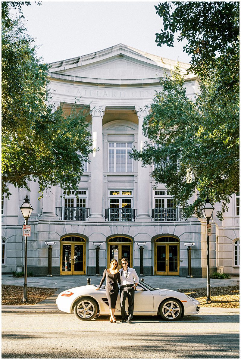 engaged couple with their vintage car at the Galliard Center in Charleston