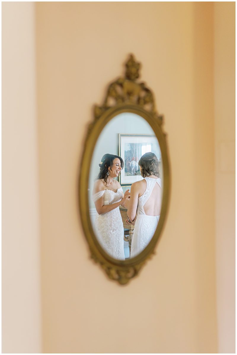 unique wedding photo of brides in a mirror 