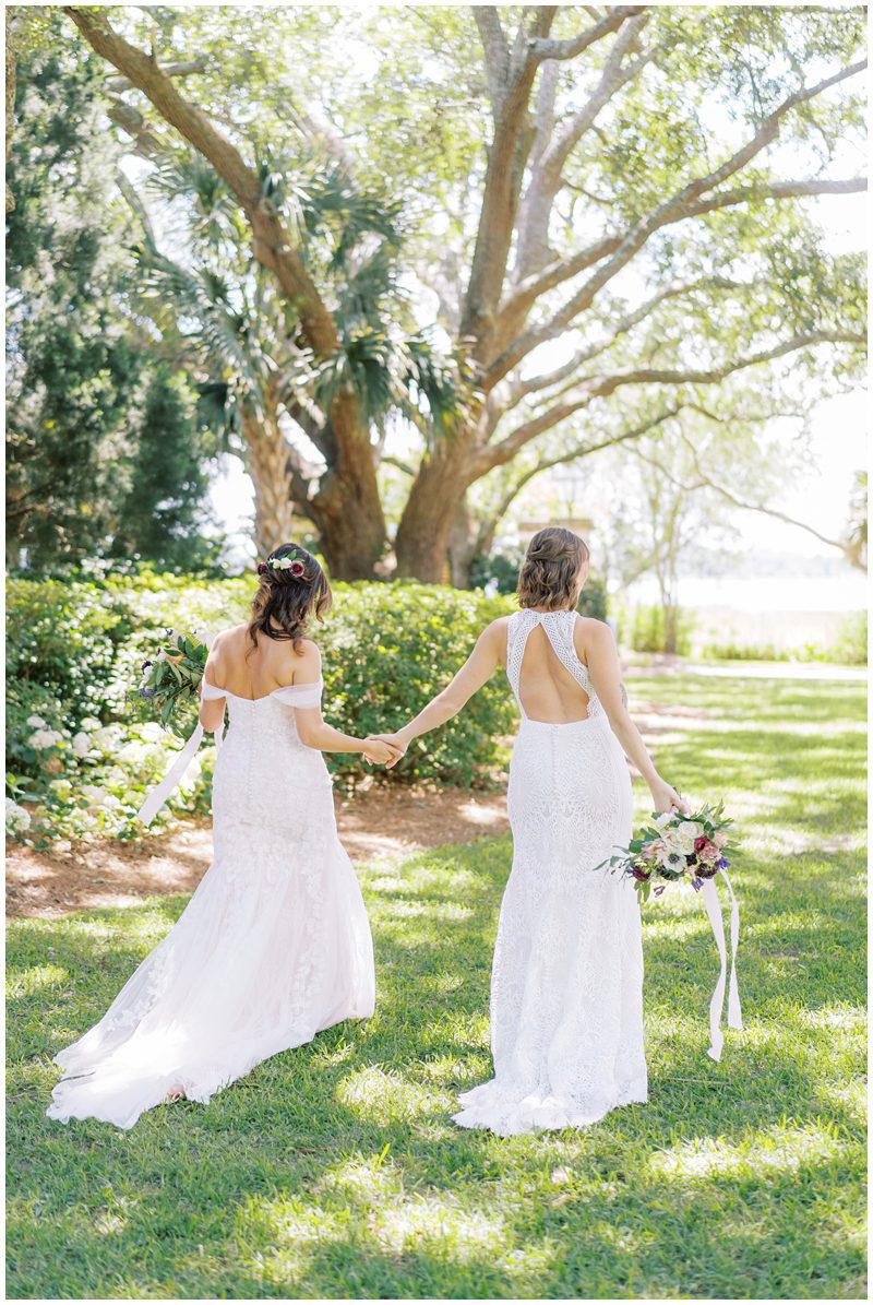two brides holding hands and walking away