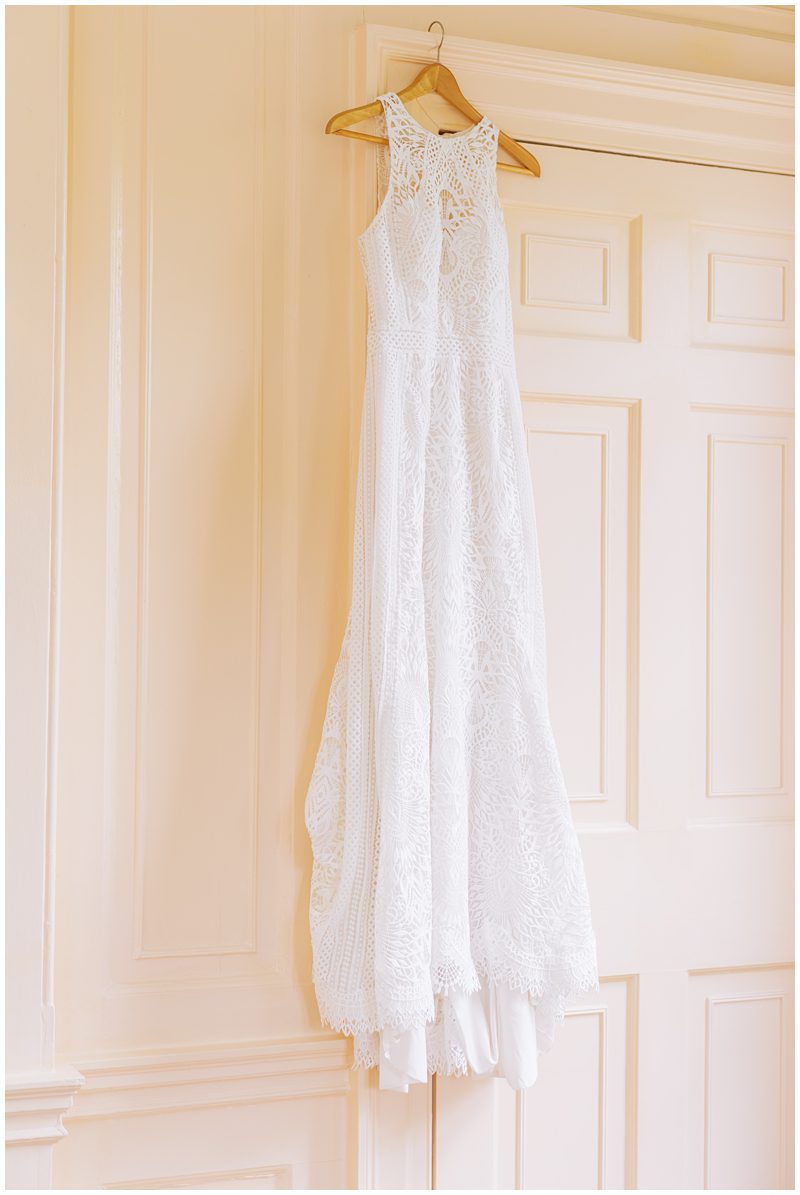 wedding dress hanging up at Lowndes Grove in the pink room