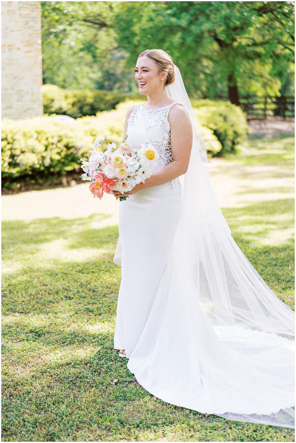 bride wearing a textured gown and cathedral length veil at her Columbia SC wedding