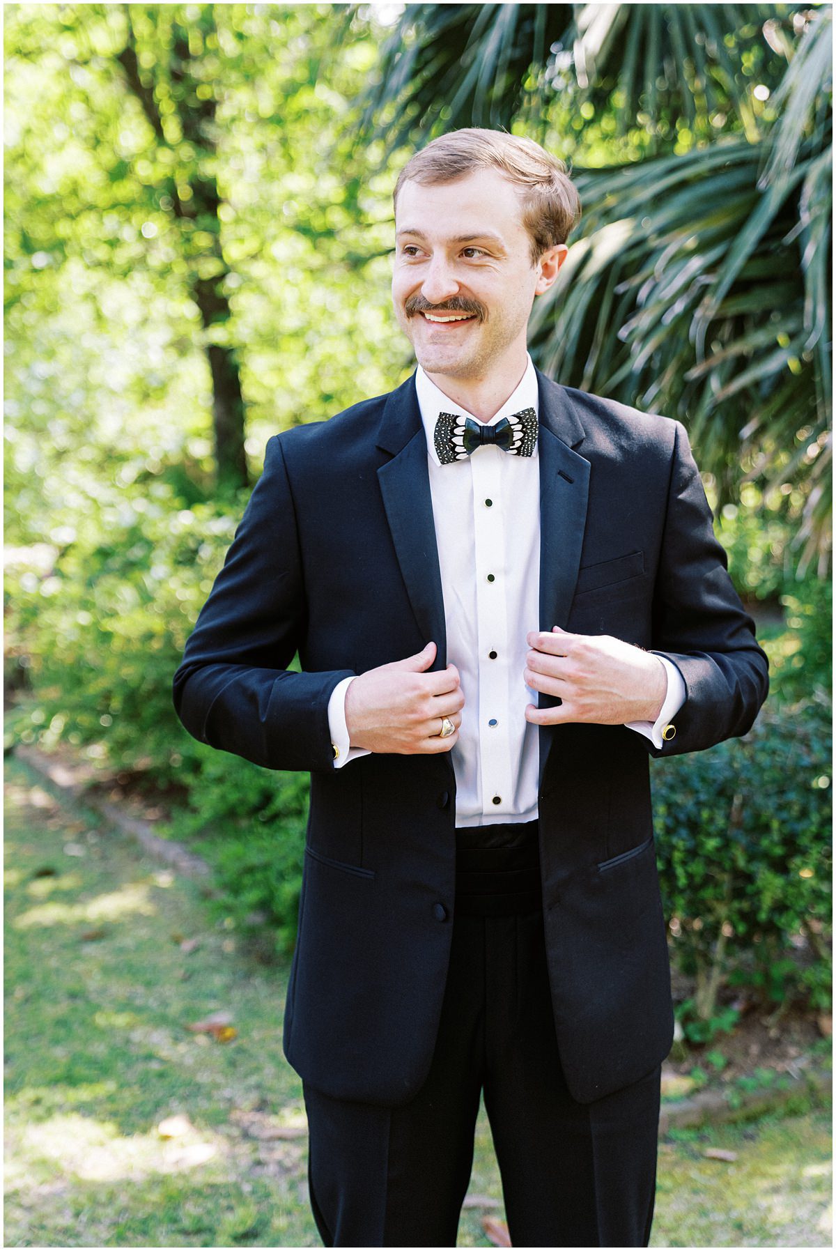modern groom wearing a black tux and brackish bowtie 