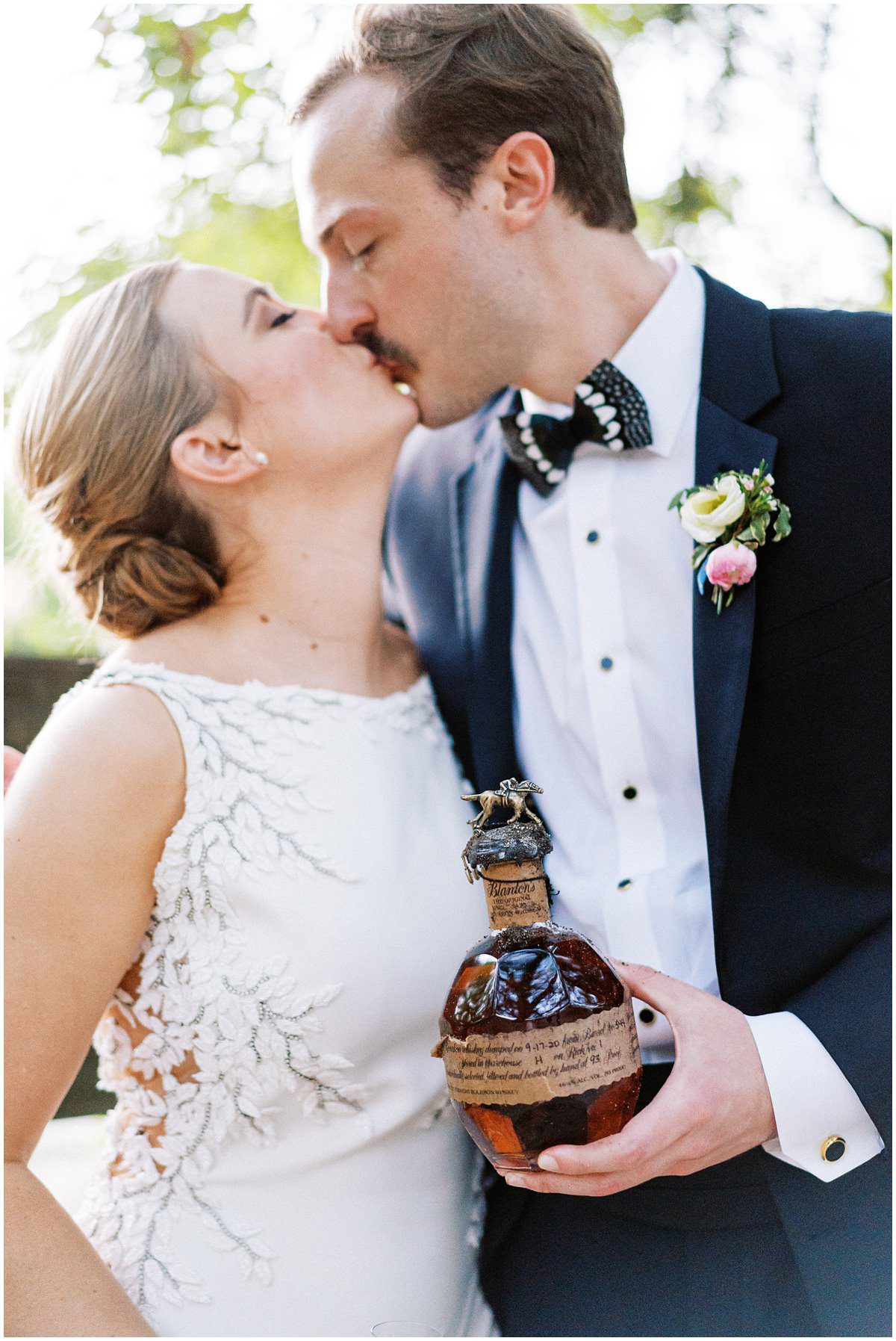 bride and groom digging up the bourbon at their wedding