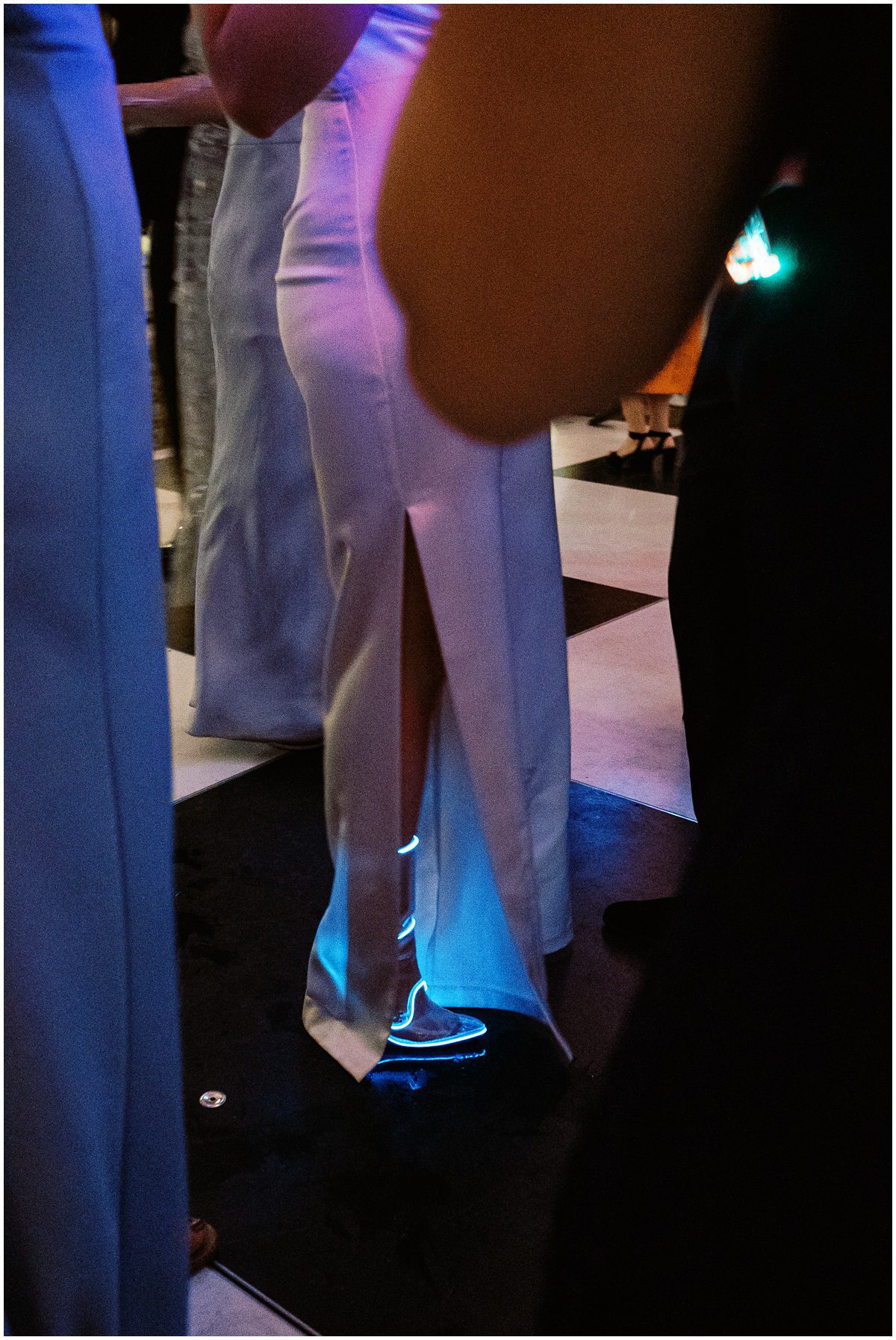 fashion forward modern bride wearing clear boots with blue neon lights