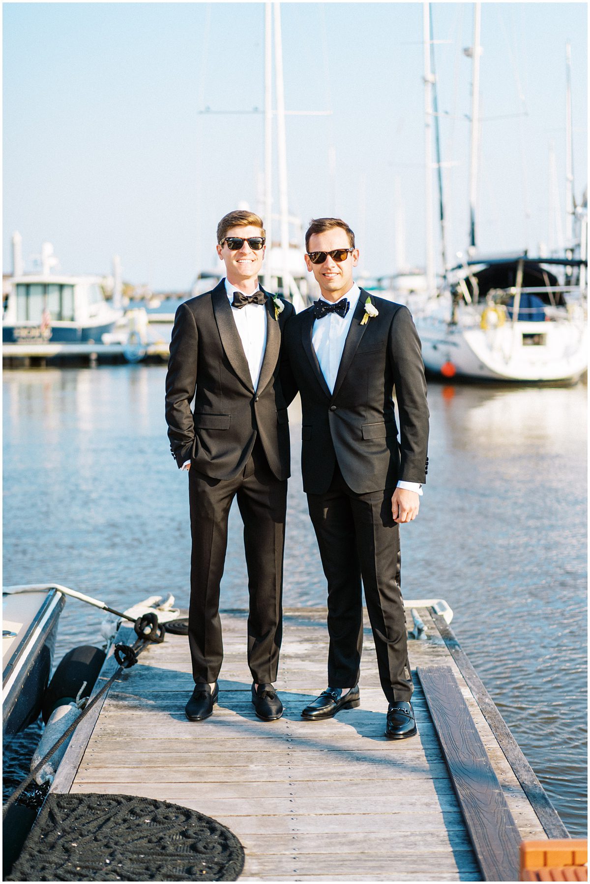 LGBTQ Wedding in Charleston on a boat with two grooms wearing tuxedos and sunglasses 