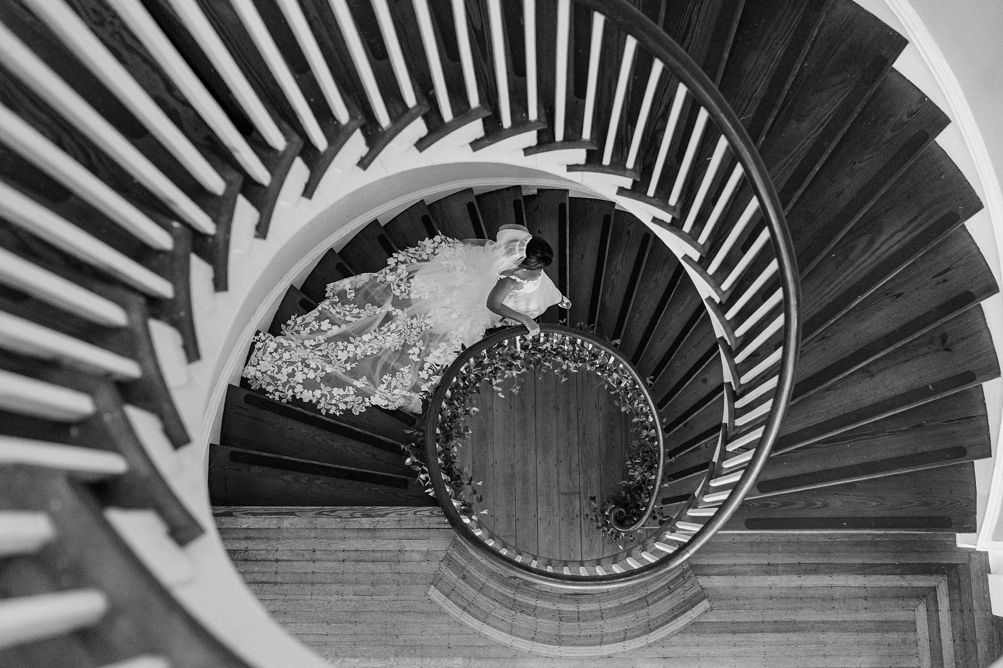 Bride walking down the spiral staircase at Lowndes Grove