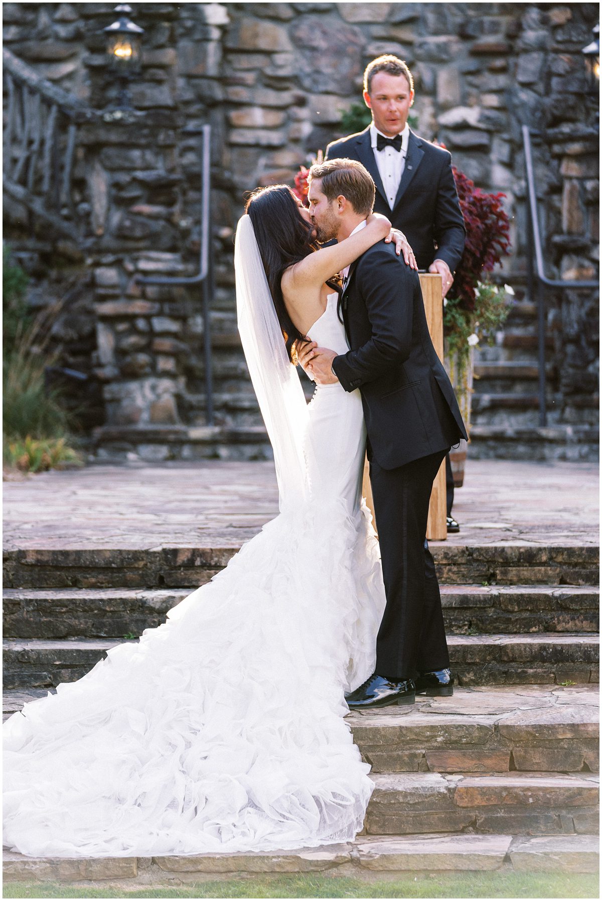 The bride and grooms first kiss at their Mountaintop Golf and Lake Club wedding in Highlands NC