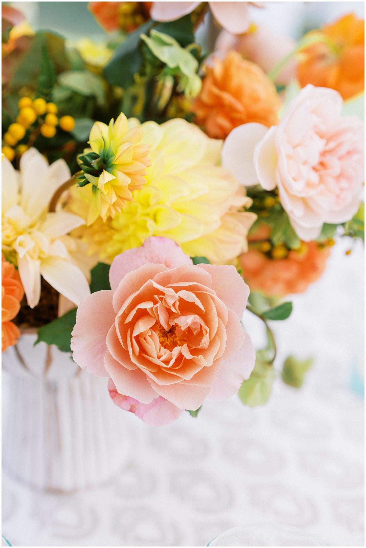 Pink, yellow, and orange flowers for a romantic fall wedding designed by Tailor and Table