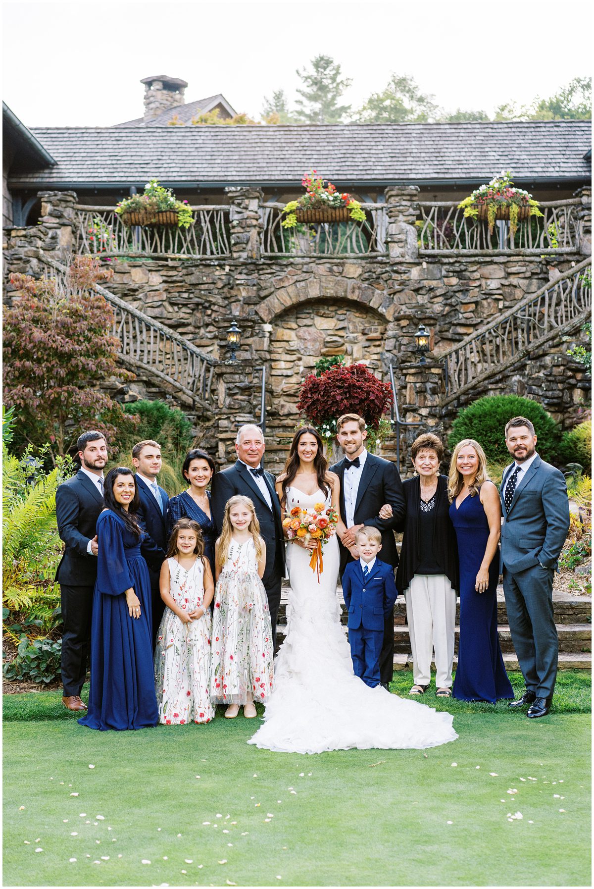 Family photo on the steps of the Mountaintop Golf and Lake Club after the wedding ceremony