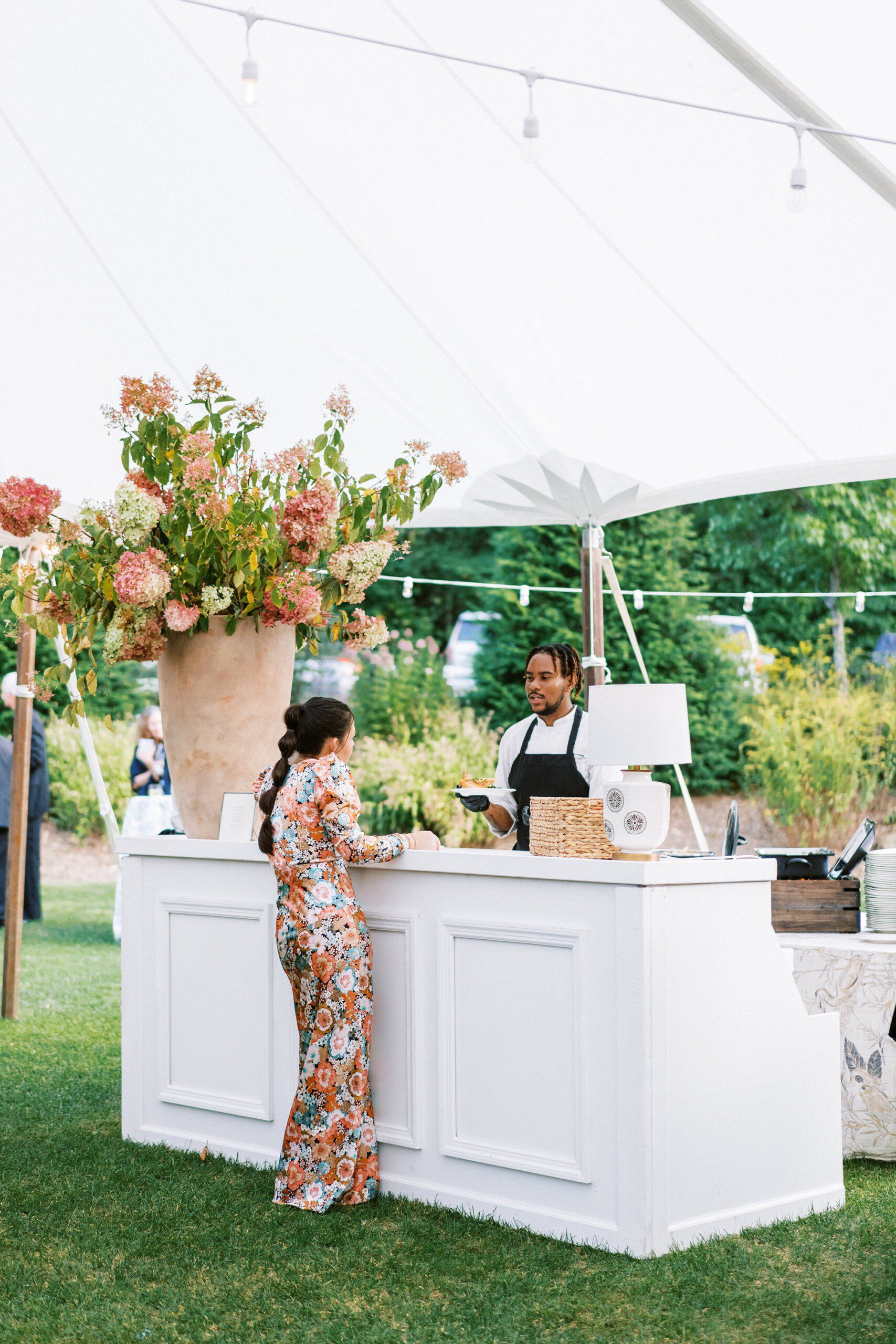 a stylish wedding guest at a tented wedding in Highlands NC