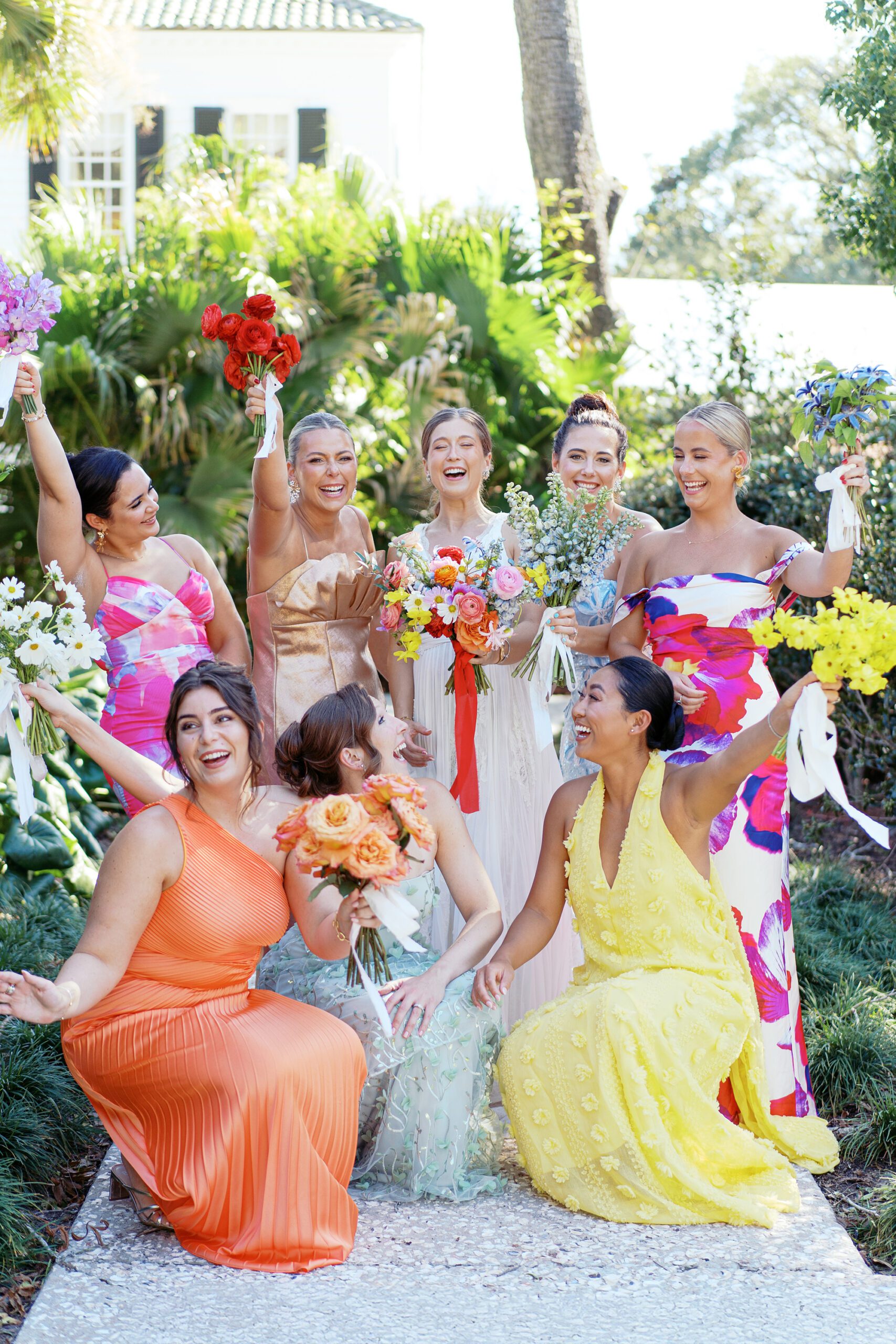 fun Boca Raton wedding photo of colorfully dressed bridesmaids laughing with the bride