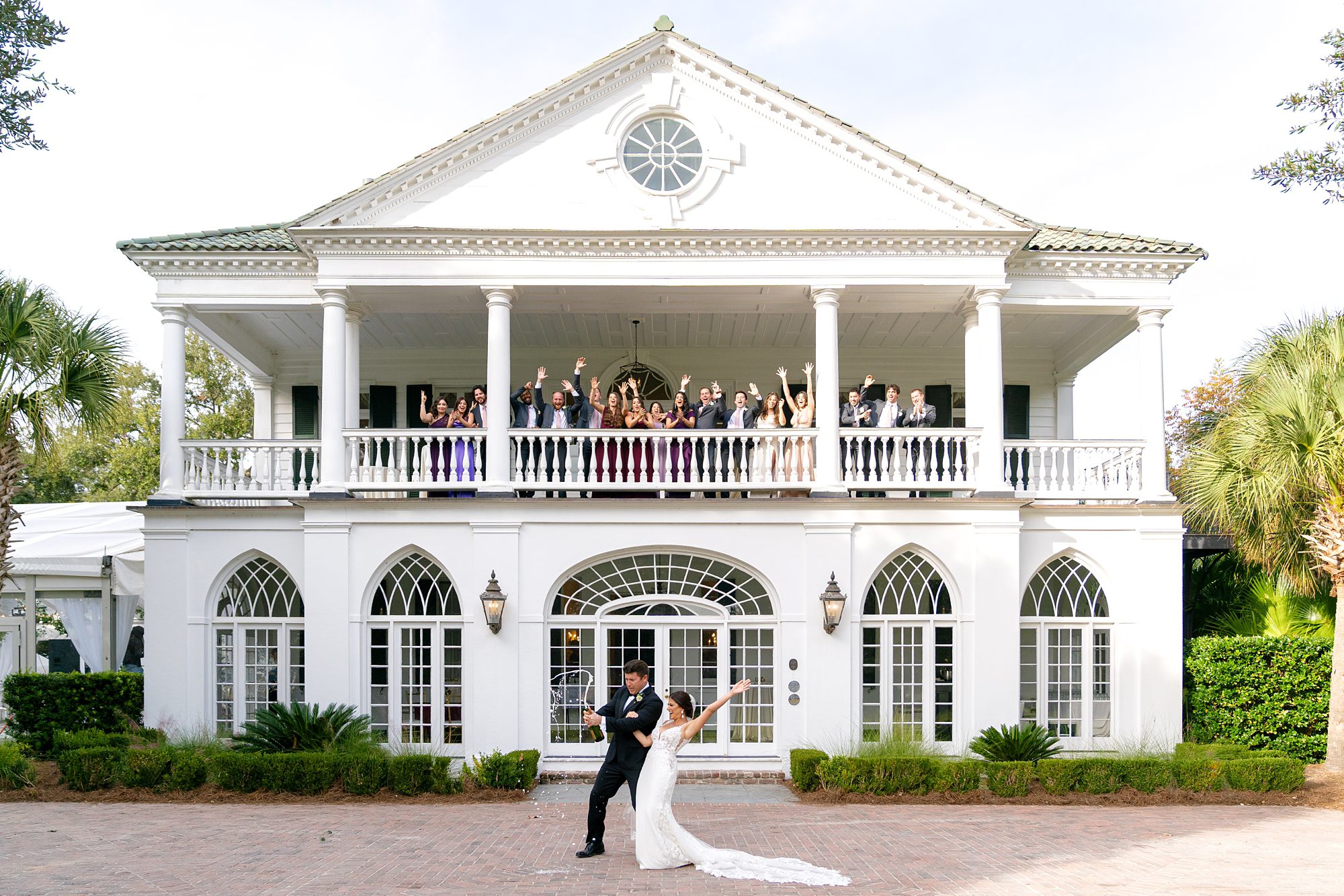 popping champagne at lowndes grove wedding
