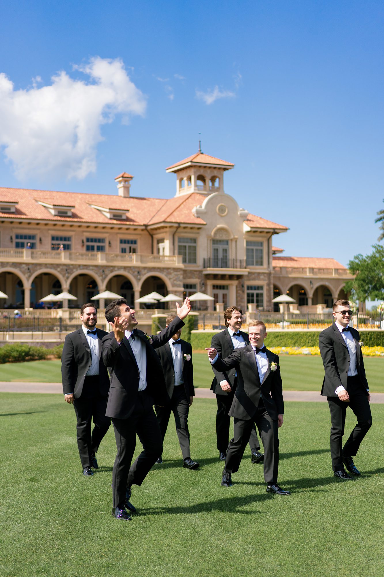 candid photo of groomsmen walking at TPC Sawgrass, a north florida wedding venue