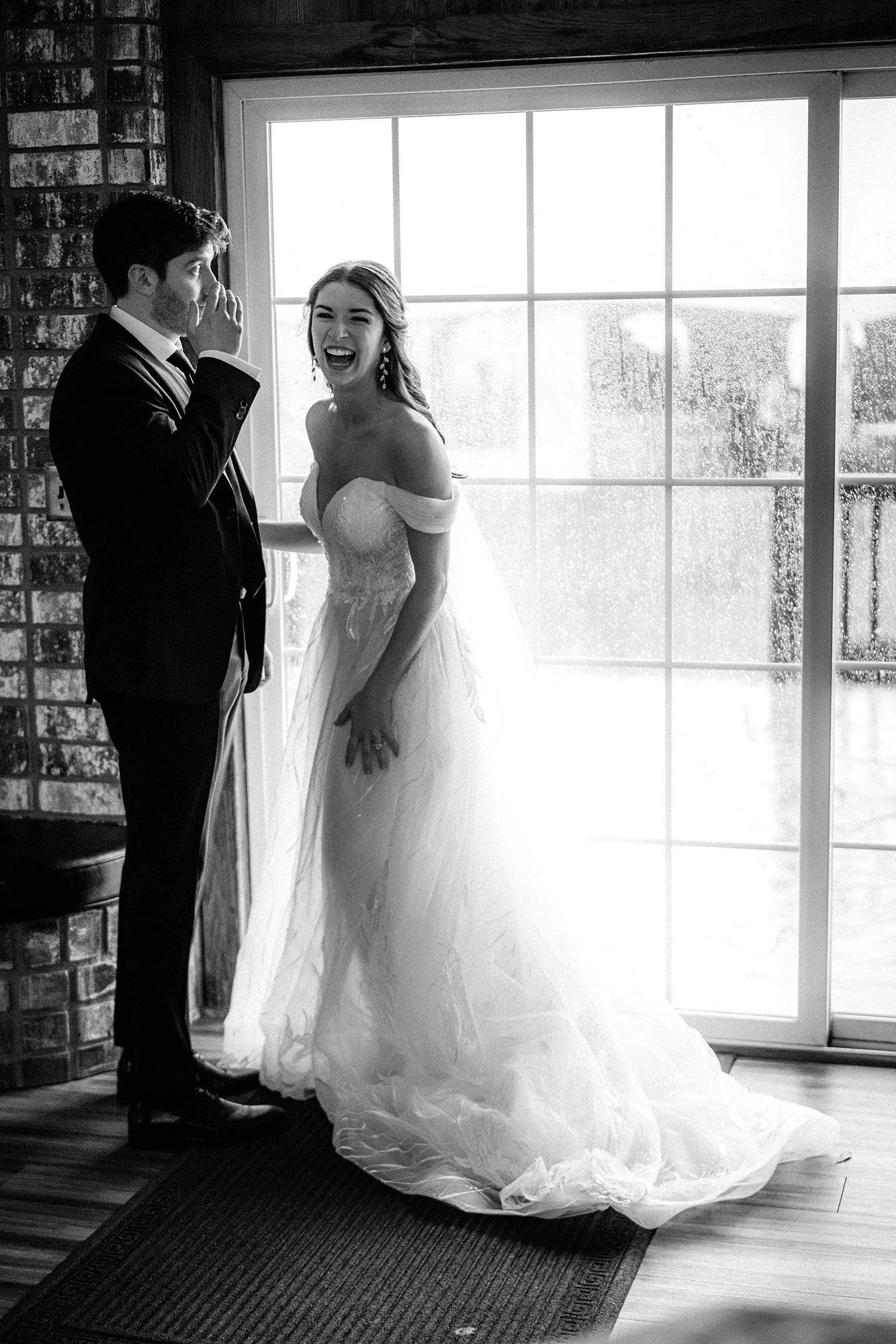 candid photo of bride and groom laughing after it rained at their backyard wedding in florida