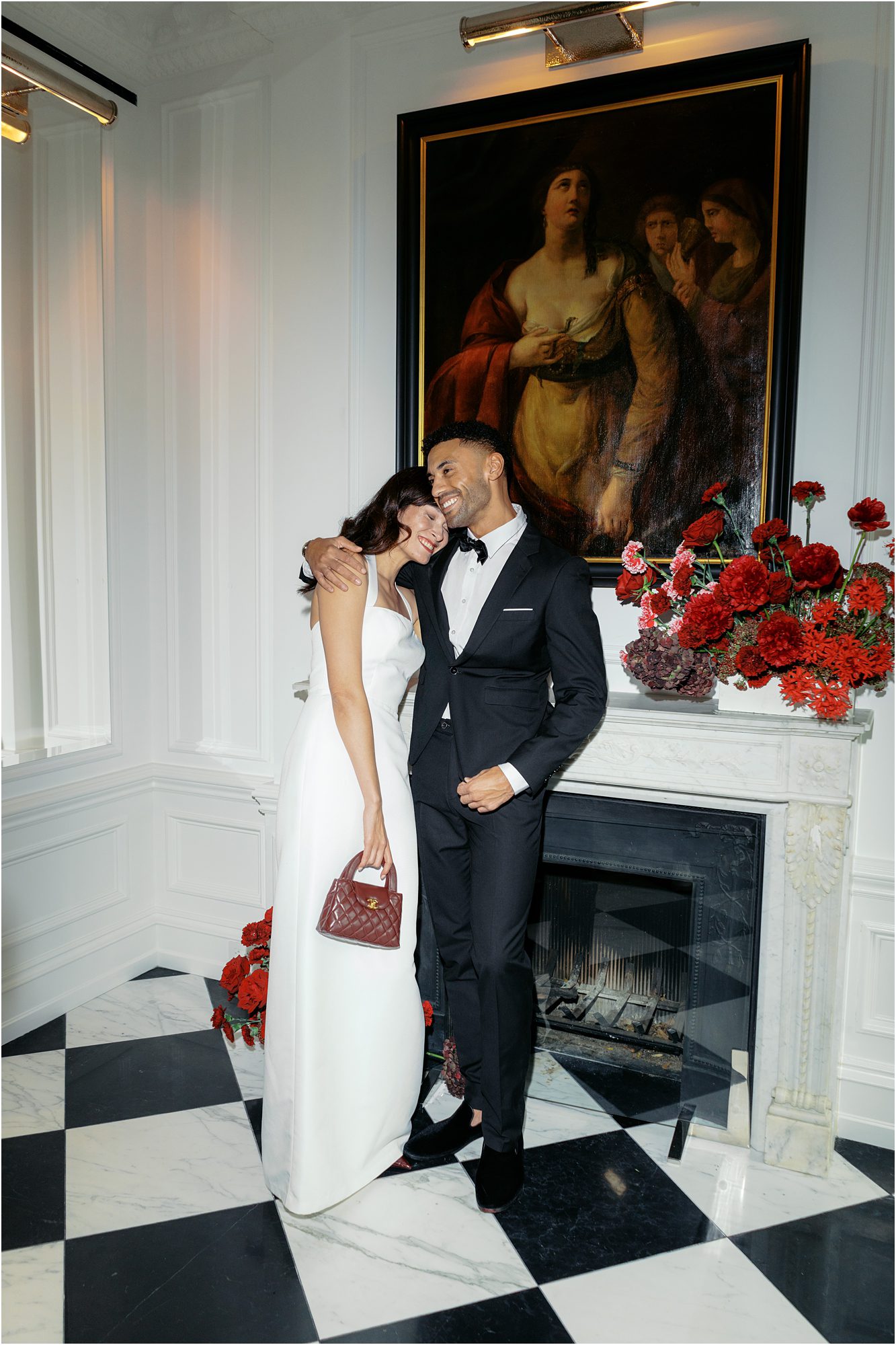 Stylish couple portrait by a fireplace inside a Manhattan brownstone in the Upper East Side during a wedding weekend