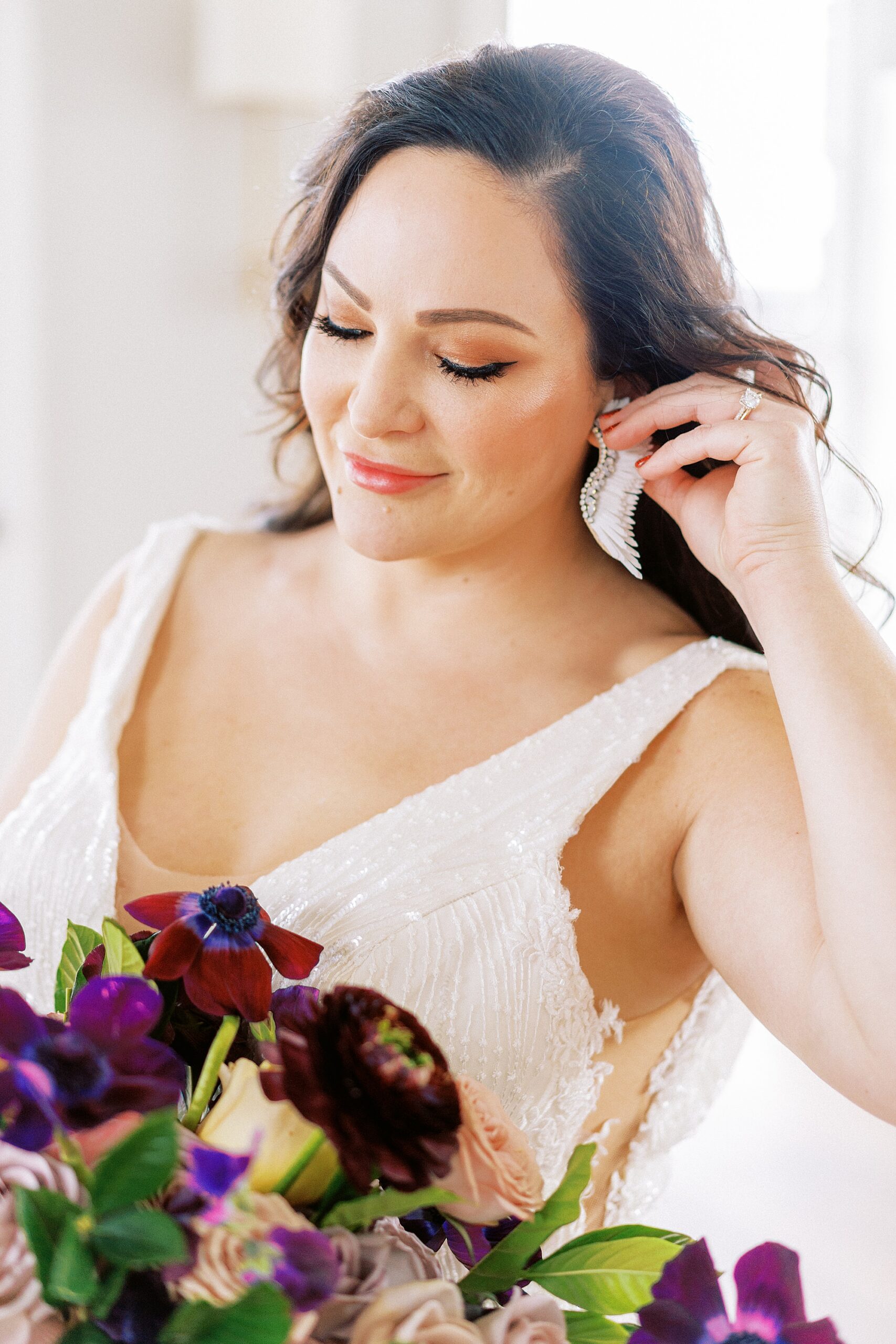 a fashionable cuban bride in a glittering gown with wing earrings at the biltmore hotel miami